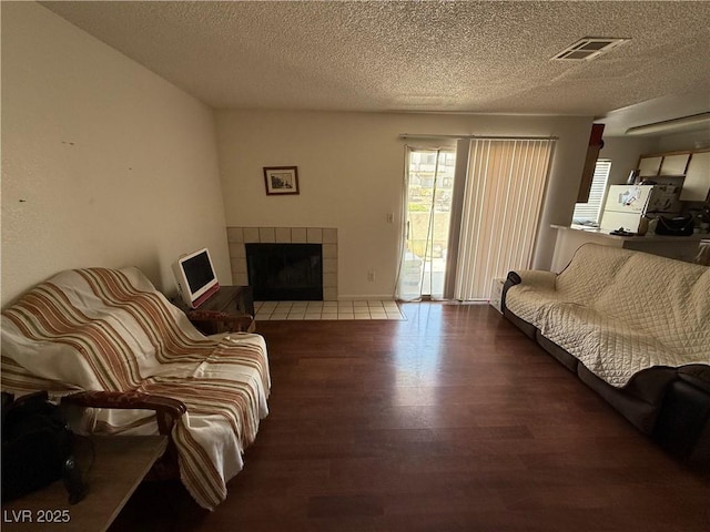 3150 Soft Breezes Dr Unit 1167, Las Vegas, NV 89128 - living area with wood finished floors, a textured ceiling, and a tiled fireplace