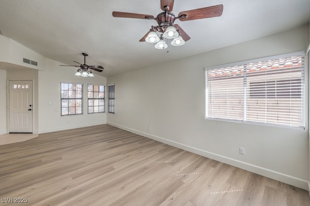 2501 Muirfield Ave, Henderson, NV 89074 - unfurnished room featuring ceiling fan, vaulted ceiling, light wood-style flooring, and a textured ceiling