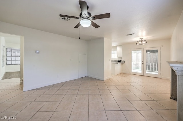 2501 Muirfield Ave, Henderson, NV 89074 - unfurnished living room with a ceiling fan, french doors, and light tile patterned floors