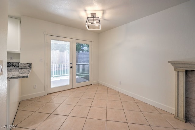 2501 Muirfield Ave, Henderson, NV 89074 - unfurnished dining area with french doors and light tile patterned floors