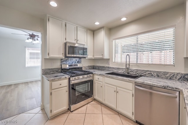 2501 Muirfield Ave, Henderson, NV 89074 - kitchen featuring appliances with stainless steel finishes, white cabinets, light stone counters, recessed lighting, and a ceiling fan