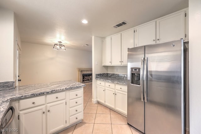 2501 Muirfield Ave, Henderson, NV 89074 - kitchen featuring appliances with stainless steel finishes, white cabinetry, light tile patterned flooring, recessed lighting, and light stone countertops