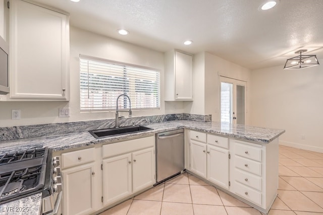 2501 Muirfield Ave, Henderson, NV 89074 - kitchen with appliances with stainless steel finishes, a peninsula, healthy amount of natural light, white cabinets, and recessed lighting