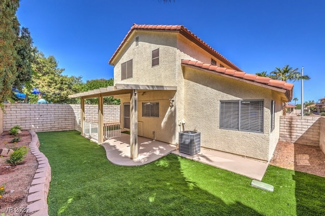 2501 Muirfield Ave, Henderson, NV 89074 - back of property with stucco siding, a tiled roof, a patio area, and a fenced backyard