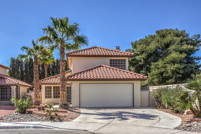 2501 Muirfield Ave, Henderson, NV 89074 - mediterranean / spanish house featuring a garage, concrete driveway, a chimney, a tile roof, and stucco siding