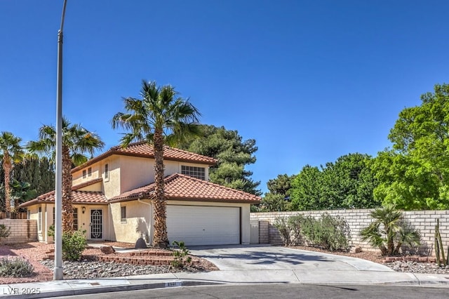 2501 Muirfield Ave, Henderson, NV 89074 - view of front of house featuring stucco siding, an attached garage, a tile roof, and concrete driveway