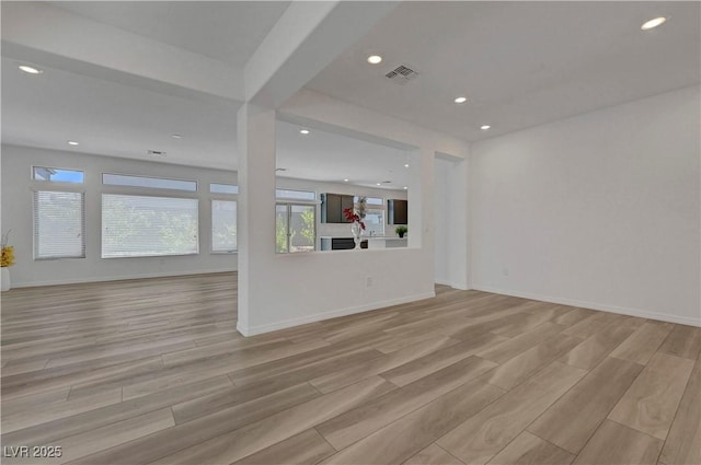 629 Soaring Wings Ave, Las Vegas, NV 89183 - unfurnished living room with plenty of natural light, light wood-type flooring, and recessed lighting