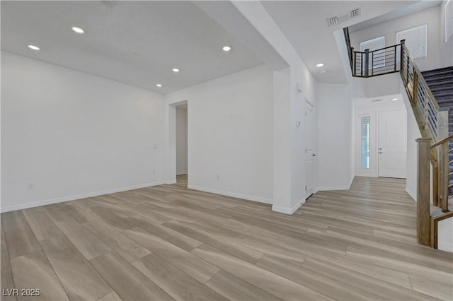629 Soaring Wings Ave, Las Vegas, NV 89183 - unfurnished living room featuring stairs, light wood-type flooring, and recessed lighting
