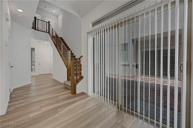 629 Soaring Wings Ave, Las Vegas, NV 89183 - entrance foyer with wood finished floors, a high ceiling, stairway, and recessed lighting