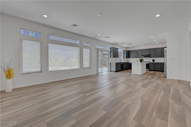 629 Soaring Wings Ave, Las Vegas, NV 89183 - unfurnished living room with light wood-style flooring and recessed lighting