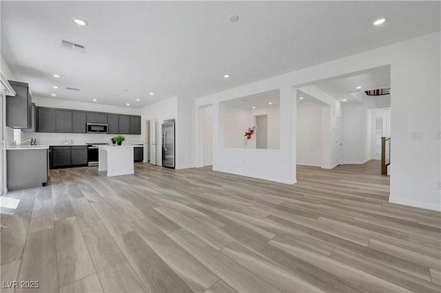 629 Soaring Wings Ave, Las Vegas, NV 89183 - unfurnished living room featuring light wood finished floors and recessed lighting