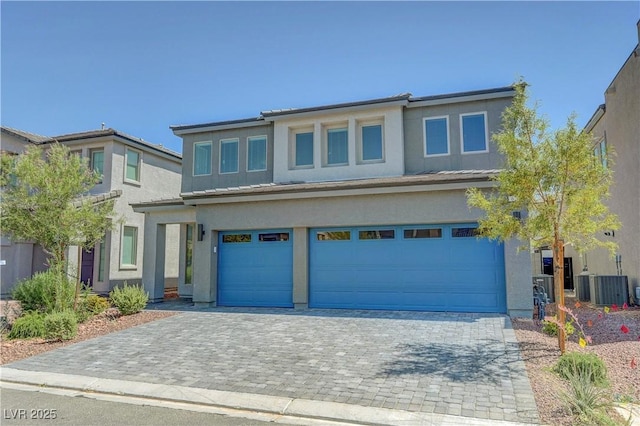 629 Soaring Wings Ave, Las Vegas, NV 89183 - view of front of house featuring an attached garage, stucco siding, and decorative driveway