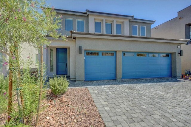 629 Soaring Wings Ave, Las Vegas, NV 89183 - traditional-style house with stucco siding, decorative driveway, and an attached garage