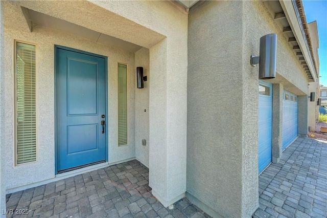 629 Soaring Wings Ave, Las Vegas, NV 89183 - view of exterior entry featuring stucco siding and a garage