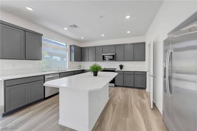 629 Soaring Wings Ave, Las Vegas, NV 89183 - kitchen with appliances with stainless steel finishes, light wood finished floors, gray cabinets, light countertops, and recessed lighting