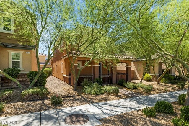 2385 Via Firenze, Henderson, NV 89044 - view of front of property with stucco siding and a fenced front yard
