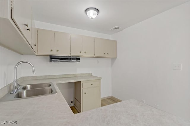 304 Orland St Unit 47, Las Vegas, NV 89107 - kitchen featuring light countertops, cream cabinetry, and light wood-style floors