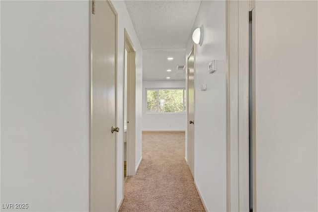 304 Orland St Unit 47, Las Vegas, NV 89107 - corridor with light colored carpet, recessed lighting, and a textured ceiling