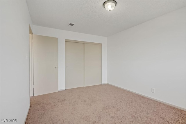 304 Orland St Unit 47, Las Vegas, NV 89107 - unfurnished bedroom with carpet floors, a closet, and a textured ceiling