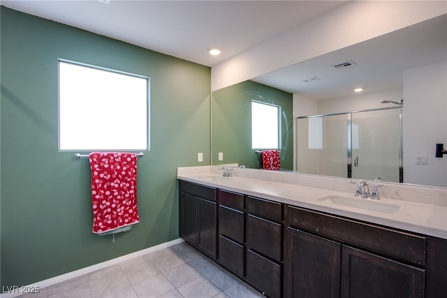 10434 Rose Palisade St, Las Vegas, NV 89141 - bathroom featuring double vanity, a stall shower, tile patterned flooring, and recessed lighting