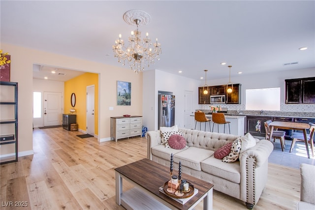 10434 Rose Palisade St, Las Vegas, NV 89141 - living room featuring light wood finished floors, a chandelier, and recessed lighting