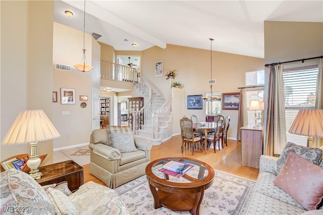 8416 Dry Cliff Cir, Las Vegas, NV 89128 - living area featuring stairway, a chandelier, high vaulted ceiling, beam ceiling, and wood finished floors