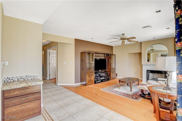 8416 Dry Cliff Cir, Las Vegas, NV 89128 - living area featuring a ceiling fan, light tile patterned flooring, and a fireplace