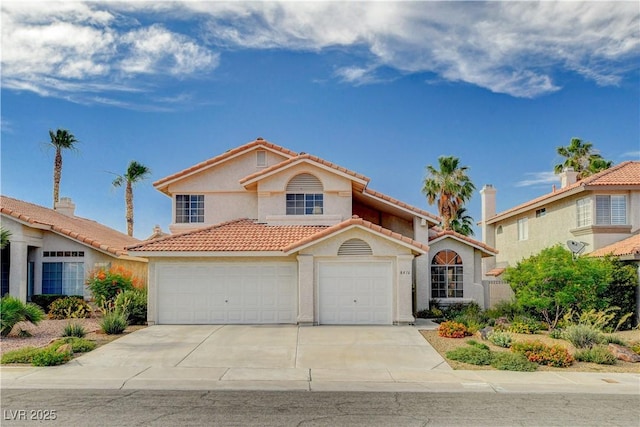 8416 Dry Cliff Cir, Las Vegas, NV 89128 - mediterranean / spanish home with stucco siding, concrete driveway, a tiled roof, and a garage