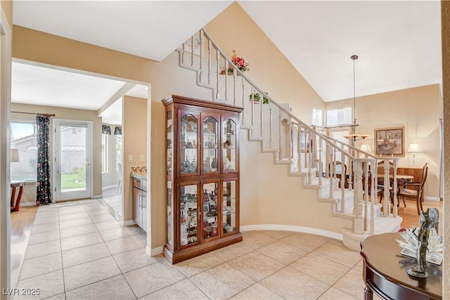 8416 Dry Cliff Cir, Las Vegas, NV 89128 - entryway featuring light tile patterned floors, stairway, and a chandelier