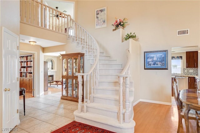 8416 Dry Cliff Cir, Las Vegas, NV 89128 - staircase featuring a towering ceiling and tile patterned floors