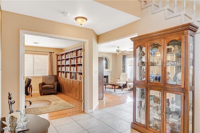 8416 Dry Cliff Cir, Las Vegas, NV 89128 - corridor with light tile patterned floors, plenty of natural light, and arched walkways