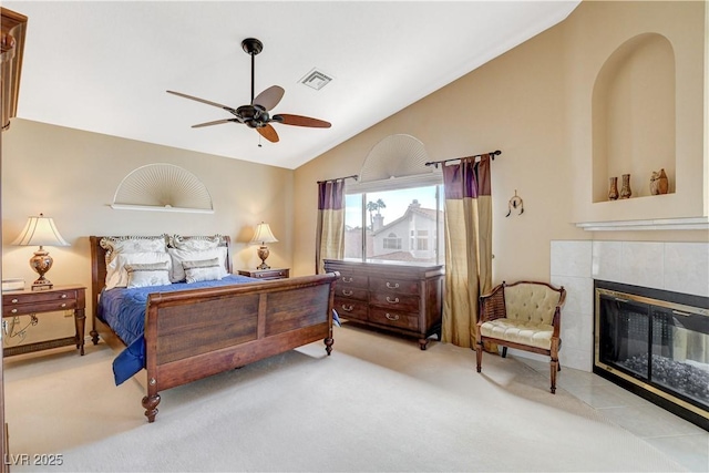 8416 Dry Cliff Cir, Las Vegas, NV 89128 - carpeted bedroom featuring vaulted ceiling, a tiled fireplace, and a ceiling fan