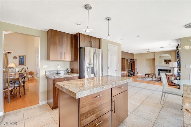 8416 Dry Cliff Cir, Las Vegas, NV 89128 - kitchen with stainless steel refrigerator with ice dispenser, open floor plan, ceiling fan, light countertops, and a center island