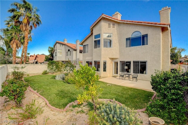 8416 Dry Cliff Cir, Las Vegas, NV 89128 - back of house with a fenced backyard, a patio area, a chimney, and stucco siding