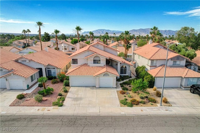8416 Dry Cliff Cir, Las Vegas, NV 89128 - view of front of property with a residential view, driveway, a tiled roof, an attached garage, and a mountain view