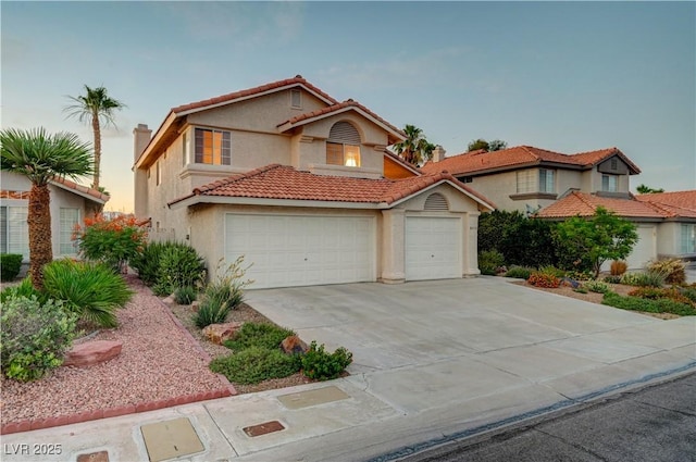 8416 Dry Cliff Cir, Las Vegas, NV 89128 - mediterranean / spanish-style house with stucco siding, concrete driveway, a tile roof, and a garage