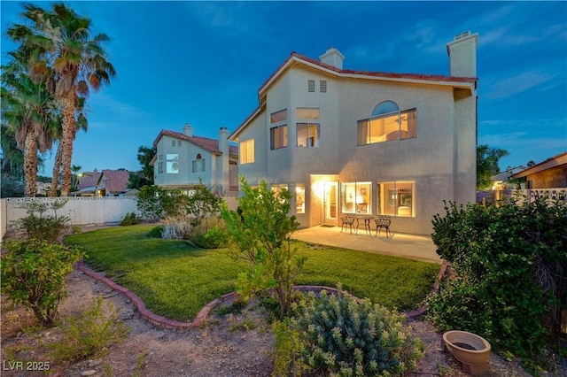8416 Dry Cliff Cir, Las Vegas, NV 89128 - rear view of house with a chimney, a patio area, stucco siding, and a fenced backyard