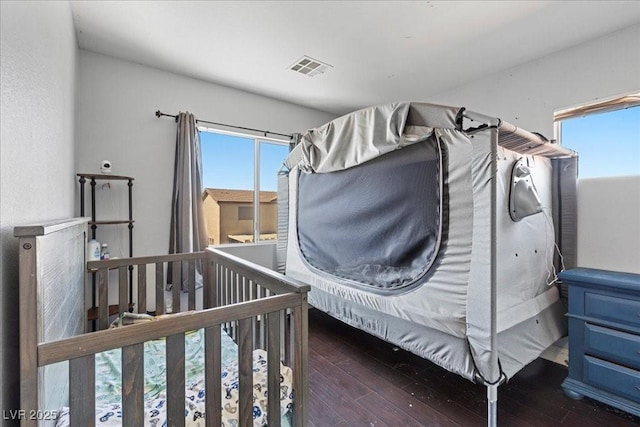 3871 Trellis View Ave, Las Vegas, NV 89115 - bedroom with multiple windows and wood-type flooring