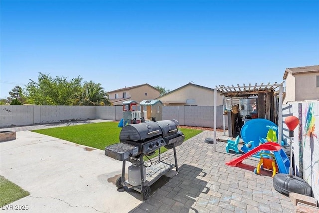 3871 Trellis View Ave, Las Vegas, NV 89115 - fenced backyard featuring a patio area, a playground, a pergola, and a grill