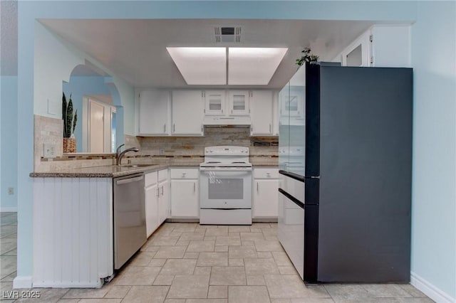 4742 Obannon Dr Unit A, Las Vegas, NV 89102 - kitchen with white electric stove, freestanding refrigerator, dishwasher, under cabinet range hood, and tasteful backsplash