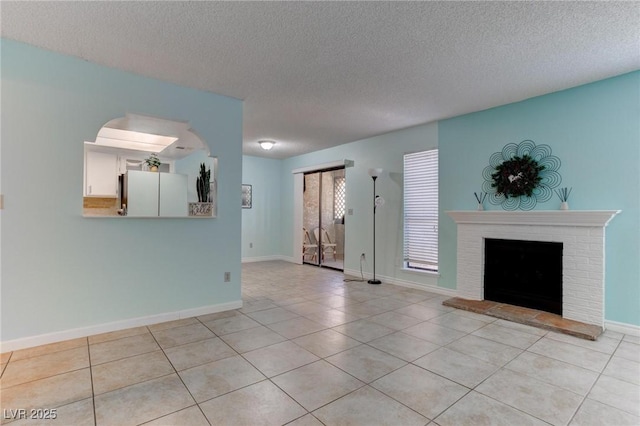 4742 Obannon Dr Unit A, Las Vegas, NV 89102 - unfurnished living room featuring light tile patterned flooring, a textured ceiling, and a brick fireplace