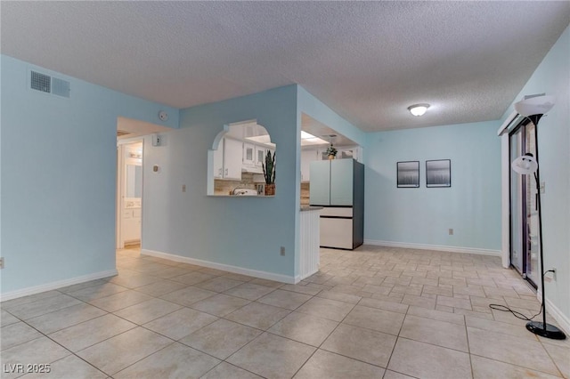 4742 Obannon Dr Unit A, Las Vegas, NV 89102 - empty room with a textured ceiling and light tile patterned floors
