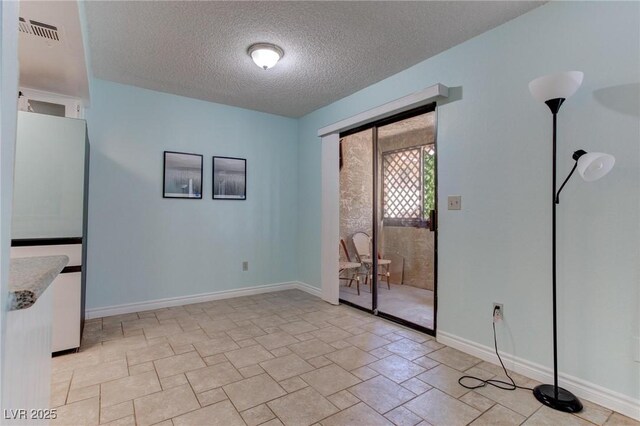 4742 Obannon Dr Unit A, Las Vegas, NV 89102 - unfurnished room with a textured ceiling and light stone finish floors