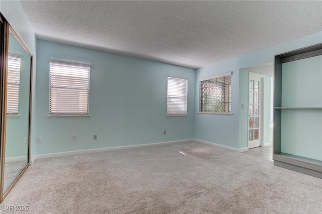 4742 Obannon Dr Unit A, Las Vegas, NV 89102 - unfurnished bedroom featuring carpet floors, a textured ceiling, multiple windows, and a closet