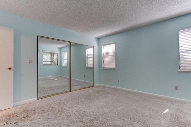 4742 Obannon Dr Unit A, Las Vegas, NV 89102 - unfurnished bedroom featuring carpet flooring, a textured ceiling, multiple windows, and a closet