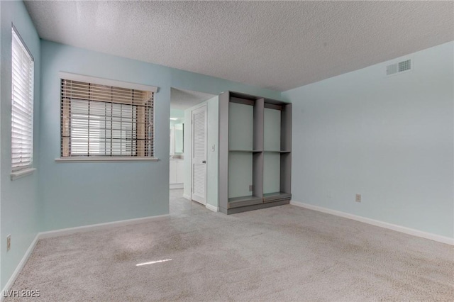 4742 Obannon Dr Unit A, Las Vegas, NV 89102 - empty room featuring carpet floors, a textured ceiling, and plenty of natural light
