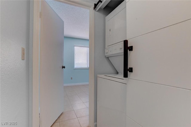 4742 Obannon Dr Unit A, Las Vegas, NV 89102 - hallway with stacked washer and clothes dryer, light tile patterned floors, and a textured ceiling