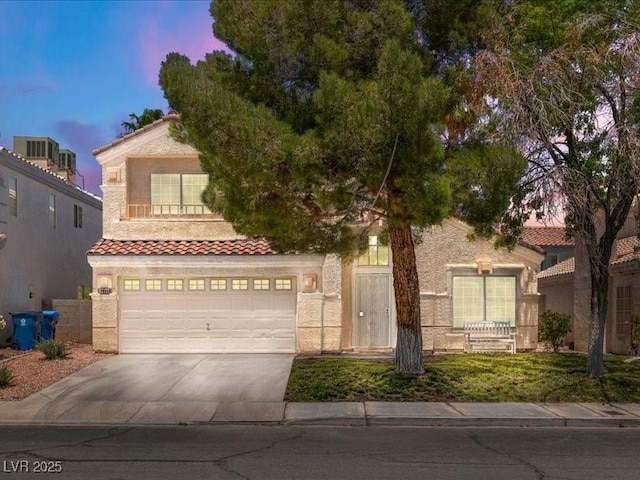 7924 Mcdowell Dr, Las Vegas, NV 89129 - mediterranean / spanish-style home featuring driveway, a tile roof, stucco siding, and an attached garage