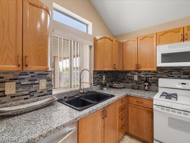 7924 Mcdowell Dr, Las Vegas, NV 89129 - kitchen featuring white appliances, plenty of natural light, lofted ceiling, tasteful backsplash, and light stone counters