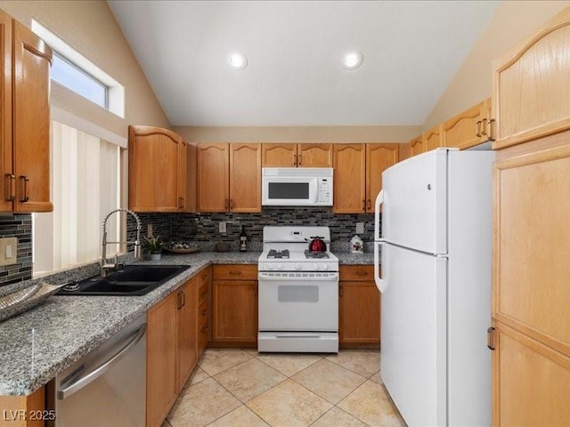 7924 Mcdowell Dr, Las Vegas, NV 89129 - kitchen featuring white appliances, lofted ceiling, tasteful backsplash, and light tile patterned floors
